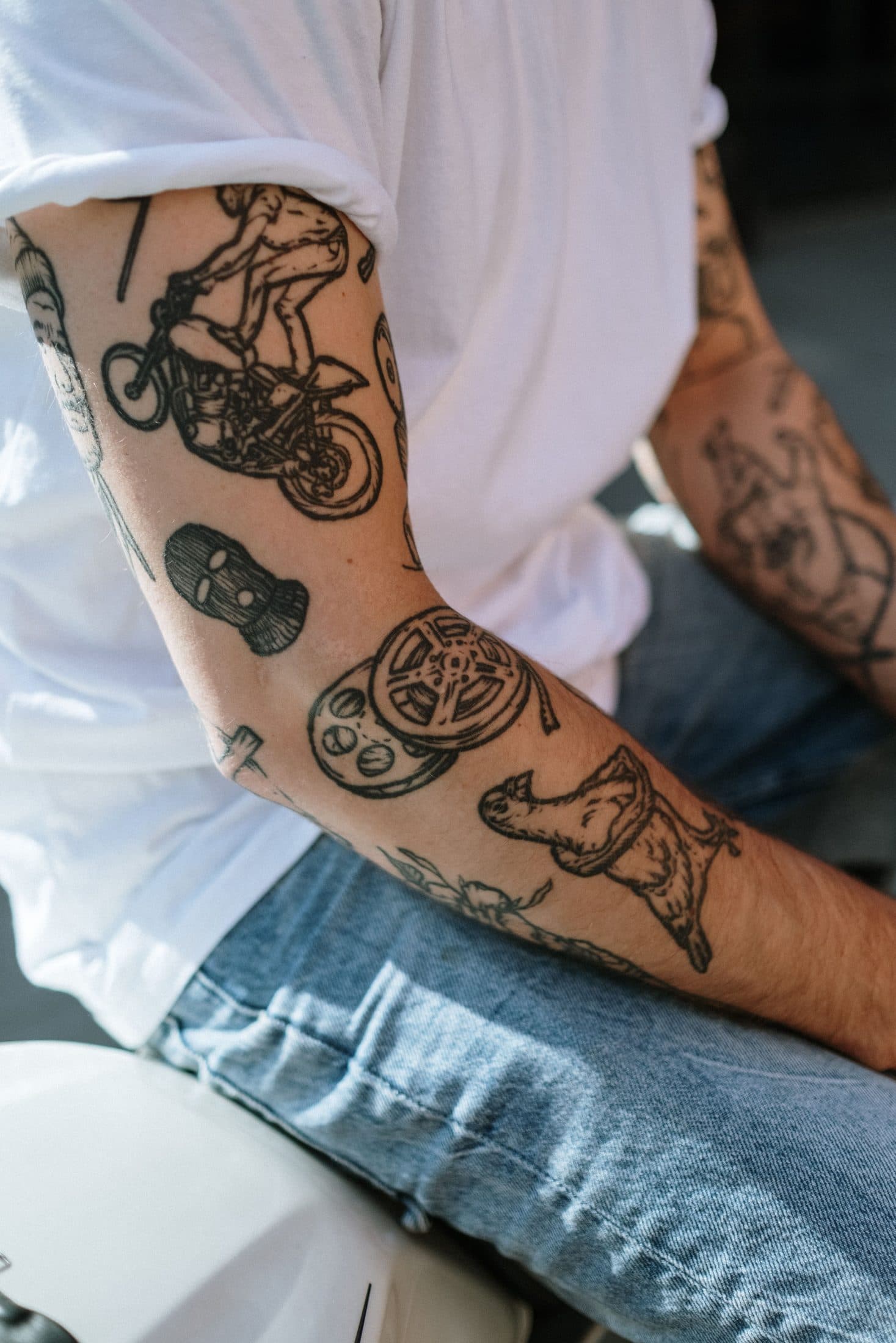 Tattooed arm in a white shirt