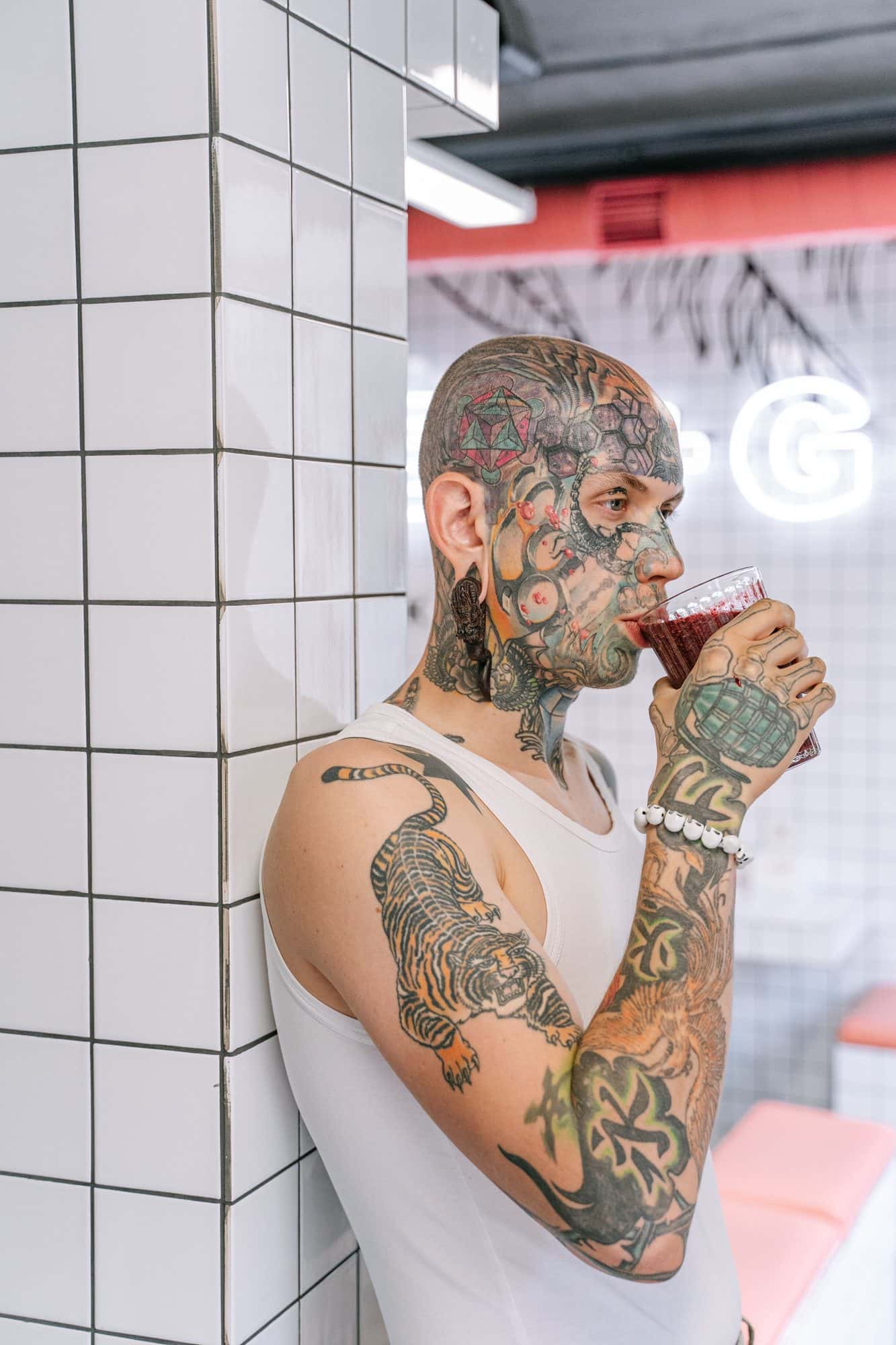 Tattoo artist with a drink, relaxed in the studio