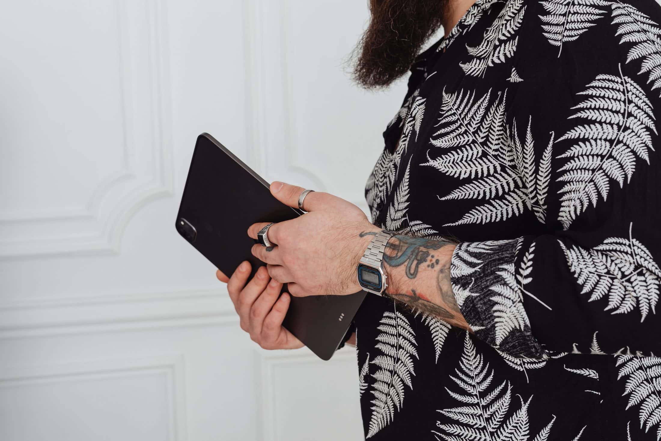 Mani tatuate tengono un iPad