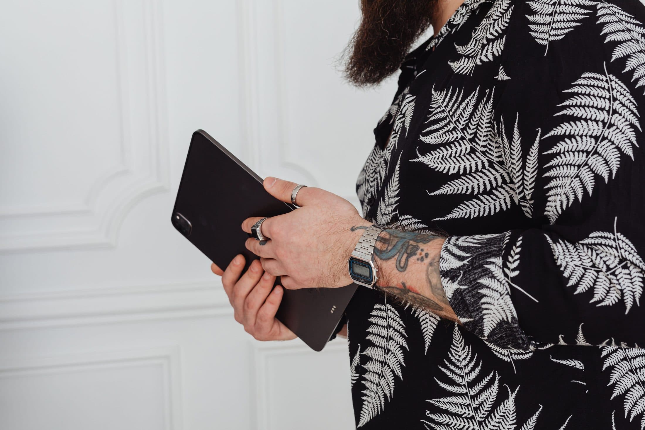 Tattooed hands holding an iPad